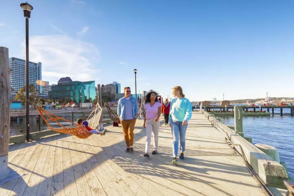 Families walking on Halifax waterfront boardwalk near Clyde House apartments