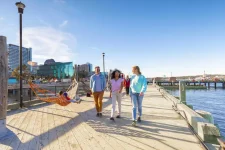 Families walking on Halifax waterfront boardwalk near Clyde House apartments
